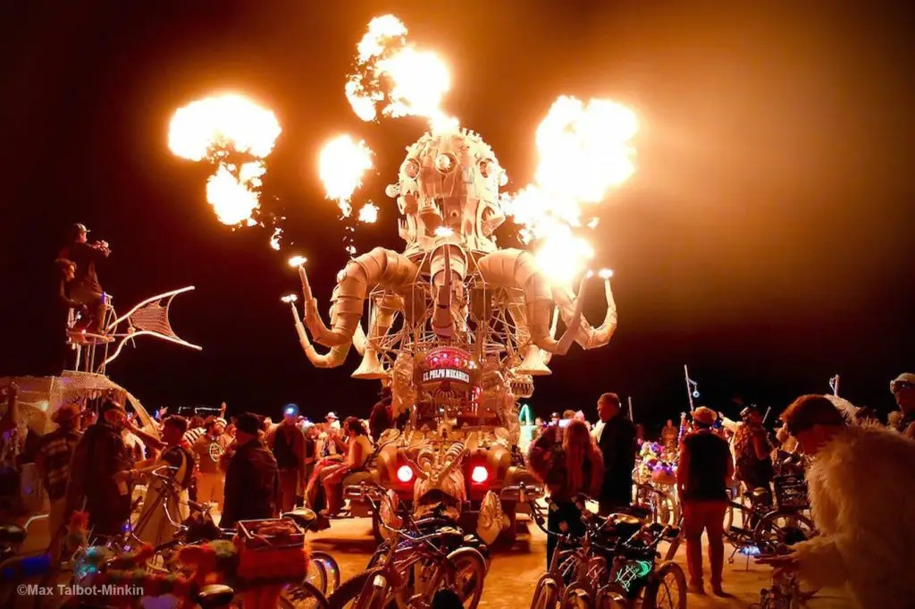 Burning man statue with crowd