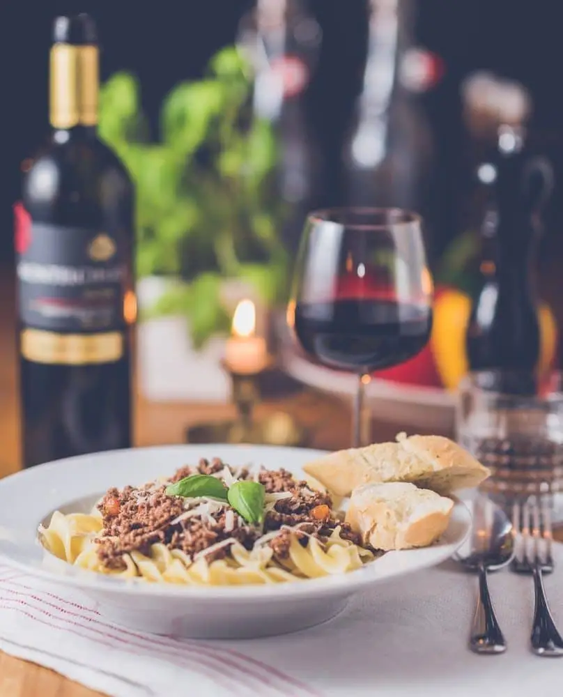 fine dining pasta with a glass of red wine